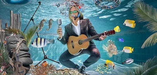 Photo of Glen playing guitar underwater in the pool. Hire Glen this summer for music by the pool, patio, or clubhouse
